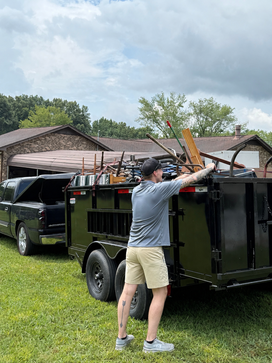 Crew loading a dump trailer at a residential job