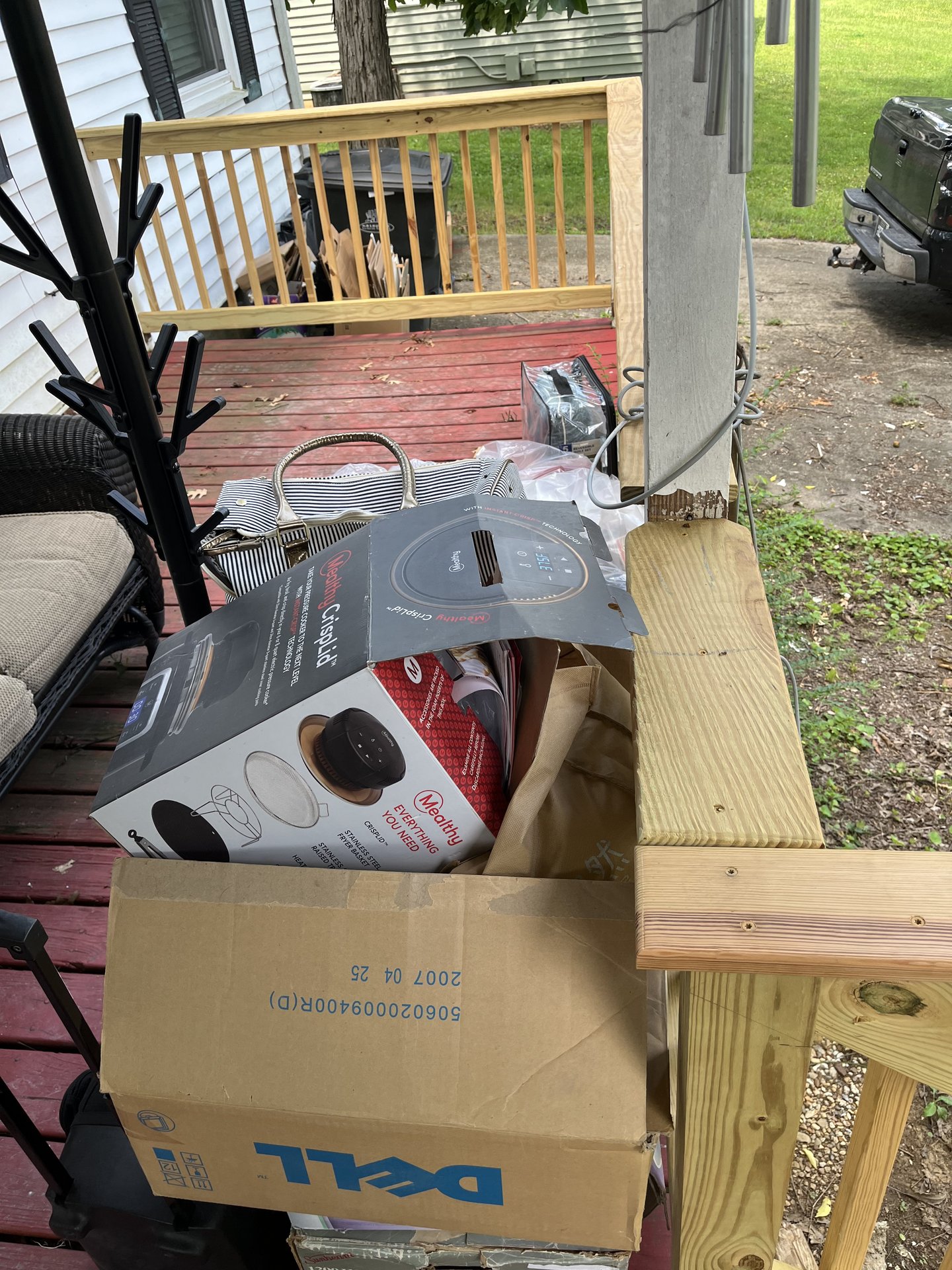 Household clutter staged on a Nashville deck for pickup
